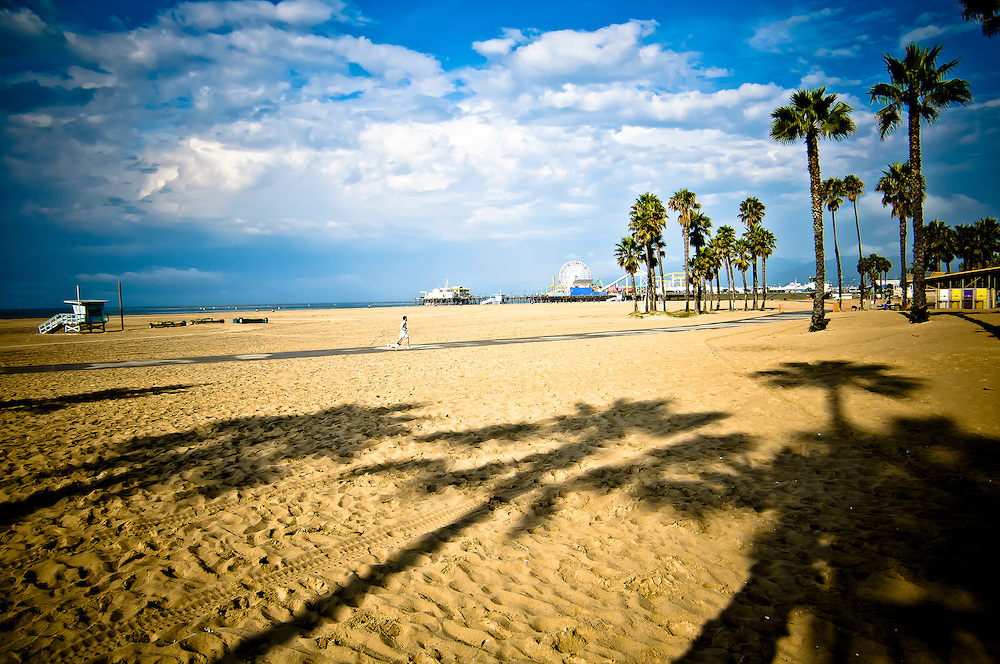A jogger runs on a sunny morning on Sanata Monica Beach, California.